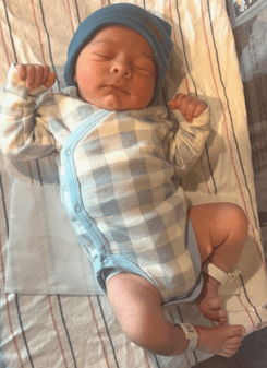 A baby lying on a blanket

Description automatically generated