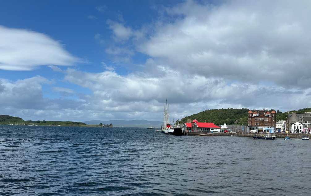 A body of water with buildings and hills in the background

AI-generated content may be incorrect., Picture